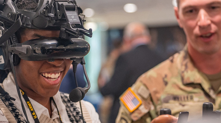 Army intern tries on a virtual reality headset