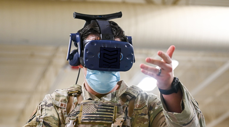 An Air Force serviceman uses an AR/VR headset