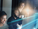 IT Help Desk image of three people working on computers 