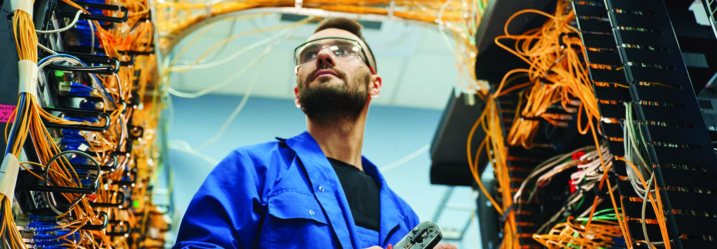 Person working with internet equipment in server room