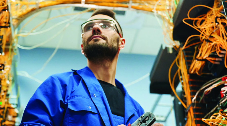 Person working with internet equipment in server room