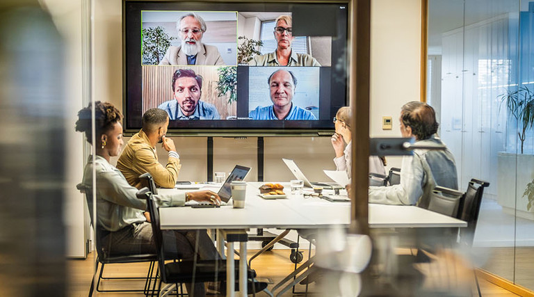 Business people attending a hybrid presentation