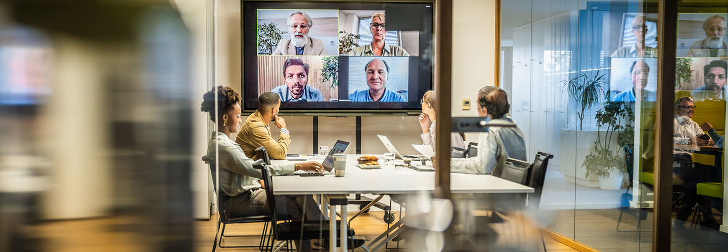 Business people attending a hybrid presentation