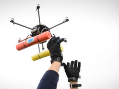 hands lifting a drone into the air